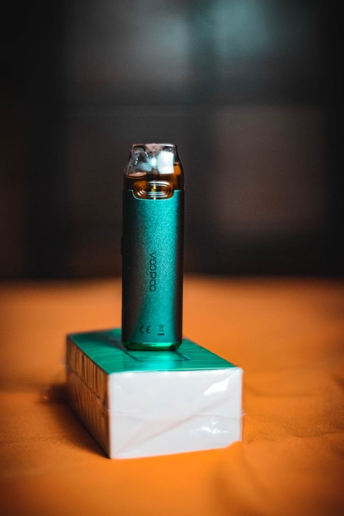 ours-journey A stylish green vape device elegantly positioned on a matching box